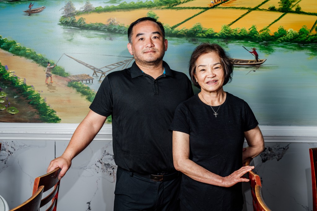 The Nguyen family, the current owners of Nam Phuong off Jimmy Carter Boulevard in Norcross, pose inside their new restaurant.