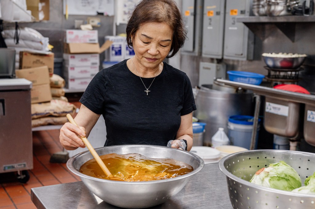 Nam Phuong owner Phú Nguyen's mother prepares food inside the kitchen of the Norcross, Georgia, restaurant.