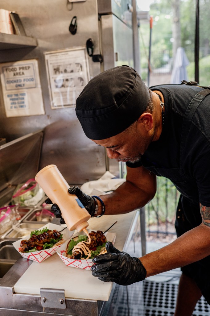 Chef Ernie Hines prepares a wrap inside his Spice the Americas food truck.