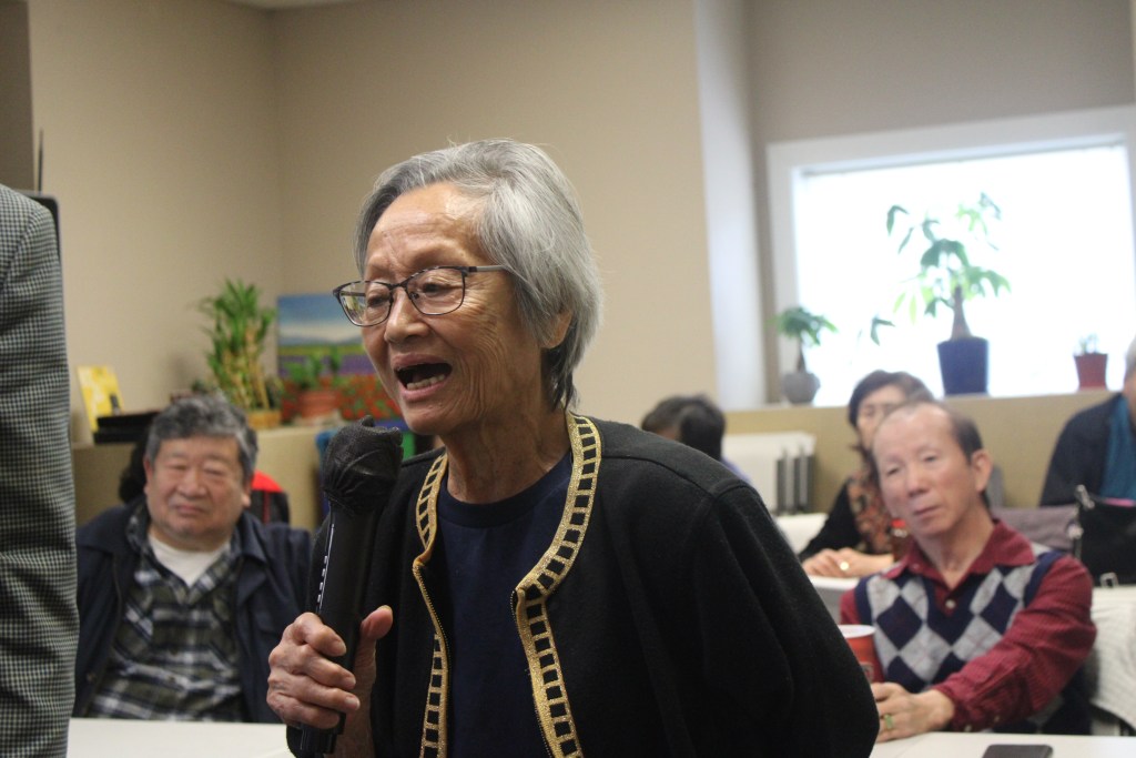 Theresa Kang sings along at a karaoke party held by the Chinese Community Federation of Atlanta in Norcross.