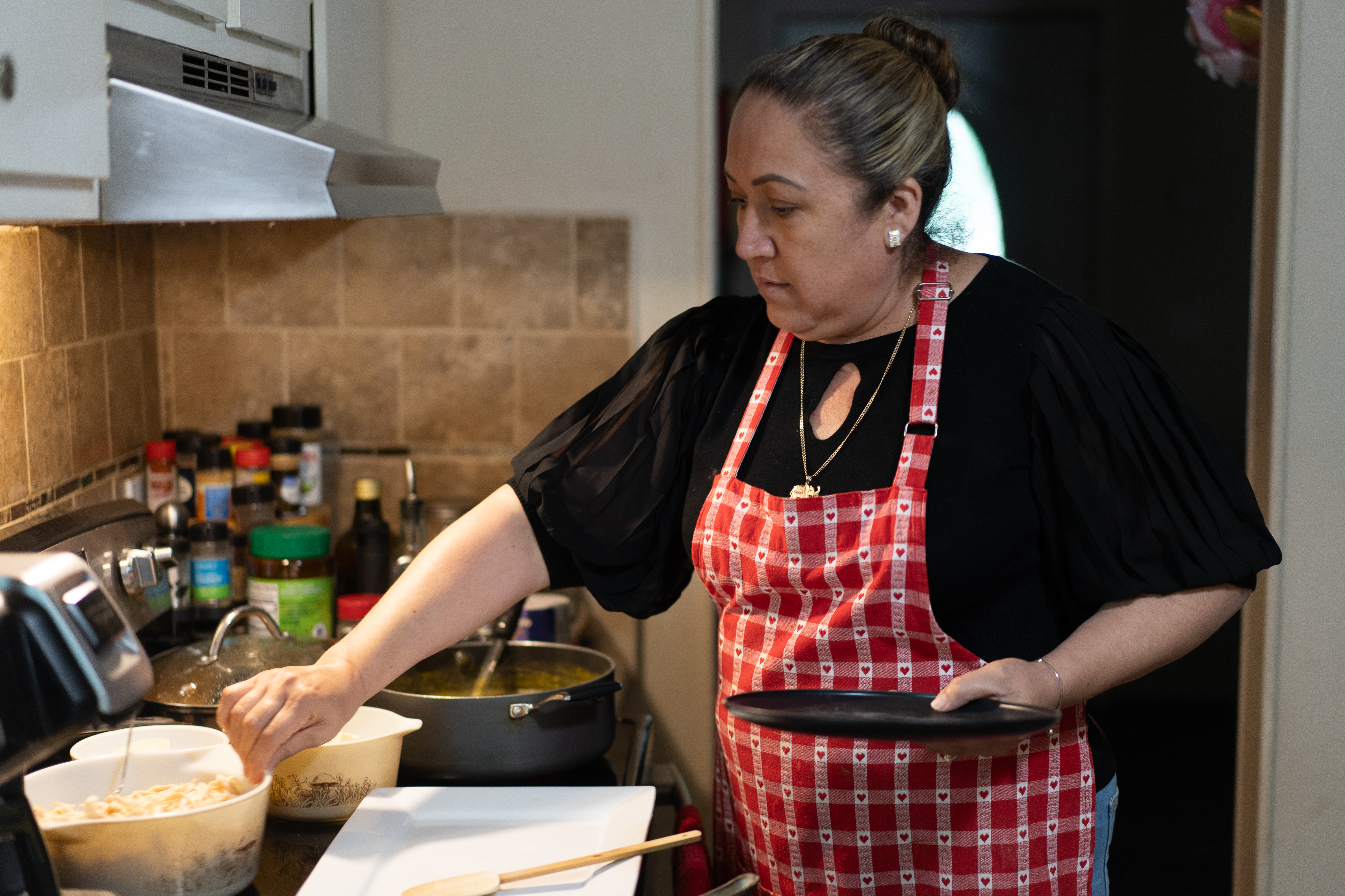 Monica Barrera prepares homemade corn tortillas using Maseca mas flour inside her Georgia kitchen.