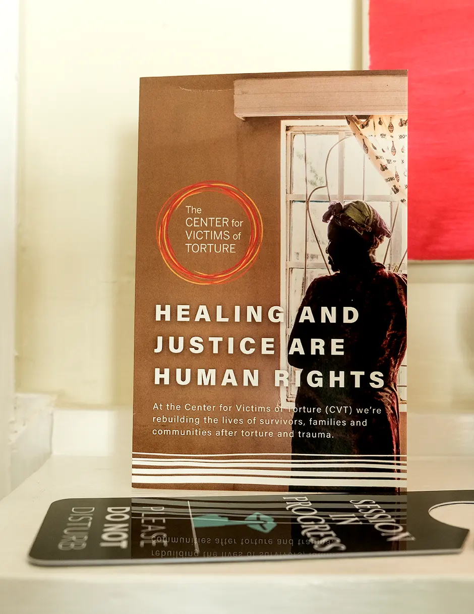 healing-justice-book-cover A table sign advertises the Center for Victims and Torture.