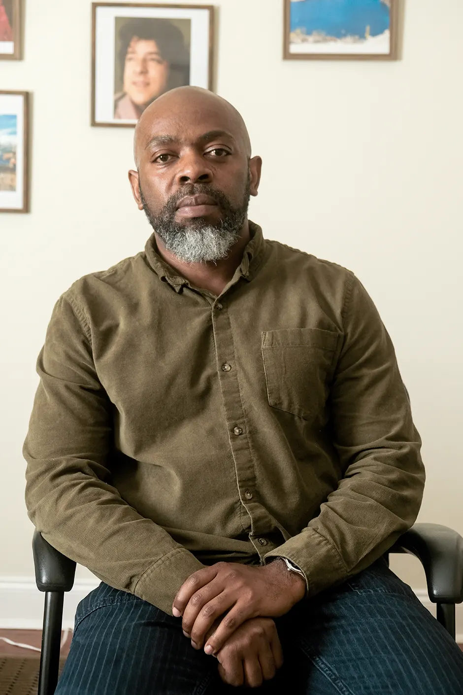léonce-byimana Léonce Byimana of the Centers of Victim and Torture sits in front of a gallery wall.