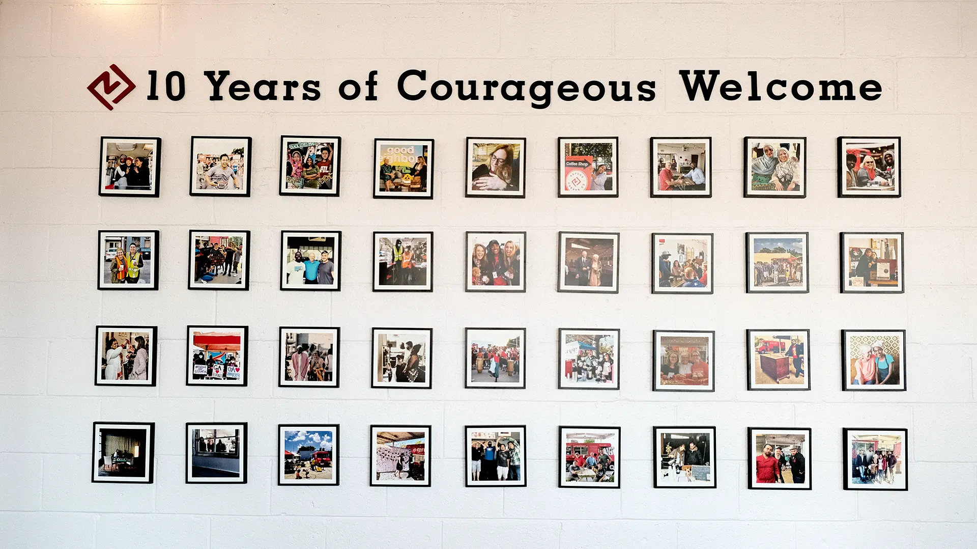 refuge-coffee-photo-wall Refuge Coffee Co. features a gallery wall under letters that read "10 Years of Courageous Welcome."