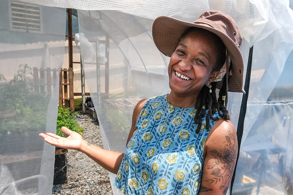 Farmer Patty Lacrete motions inside one of greenhouses in East Point, Georgia.